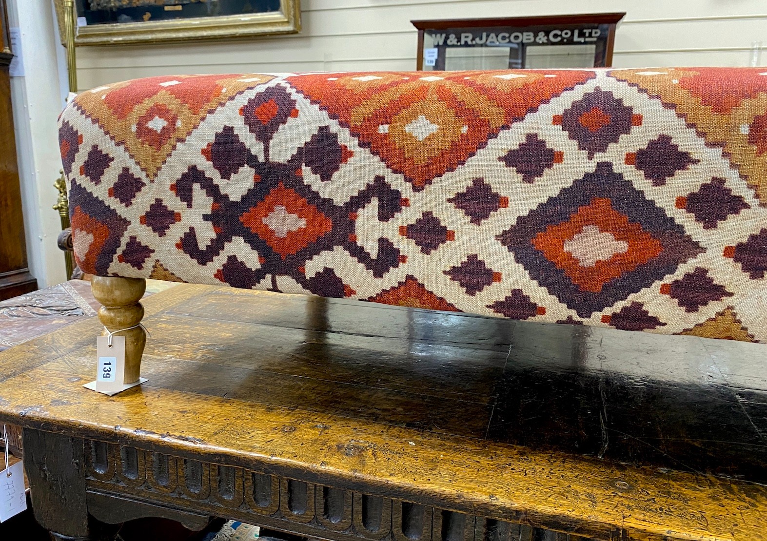 A large contemporary rectangular footstool upholstered in Kilim style fabric on turned beech feet, length 125cm, depth 74cm, height 39cm